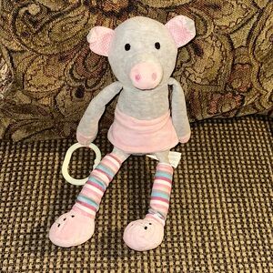 Infant Hanging Scentsy Buddy pig Wearing Leg Warmers and a Pink Skirt.